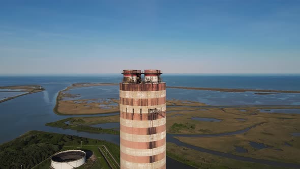 Aerial view of old thermoelectric plant with big chimne in a rural landscape