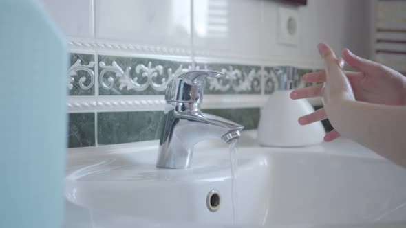 Side View of Unrecognizable Little Girl Washing Hands with Liquid Soap and Water. Diligent Child