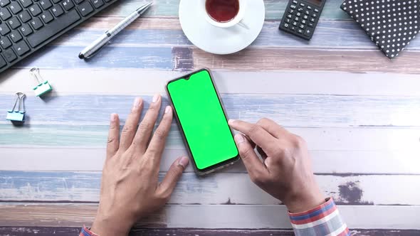 Businessman Using Smart Phone with Green Screen, Top View 