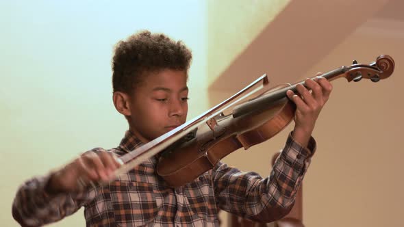 Smiling Afro Kid Plays on Violin.