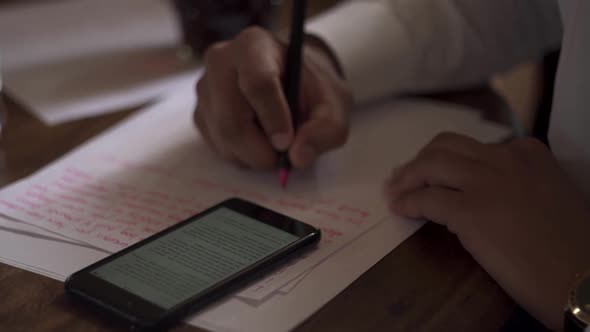 Male hands write letter on white paper on wooden table. Groom’s vow to bride. Luxury wedding day