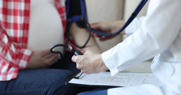 Doctor Checks Blood Pressure of Pregnant Woman