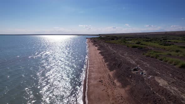 A Beach with Blue Water Color and Sandy Waves