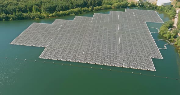 Floating solar panels cell platform system park farm in a blue lake of aerial view