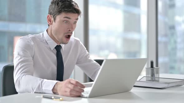 Disappointed Young Businessman in Shock at Work