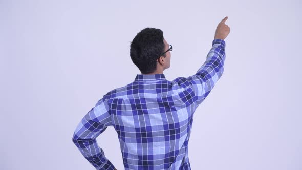 Rear View of Young Indian Hipster Man Pointing Finger