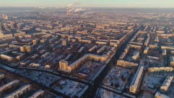 Dwelling District with Snowy Parks in Modern City at Sunset