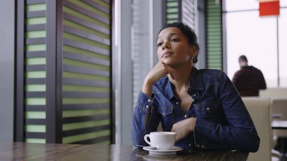 Tired Young African American Woman is Sitting in Mall Cafe After Exhausting Shopping