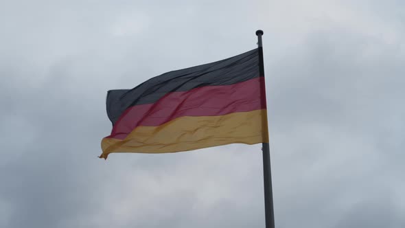 SLOW MOTION: Close Up of Beautiful German Flag Waving in the Wind with Overcast