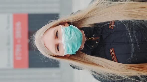 Medium Shot of Blonde Woman in a Medical Mask Walking Down the Street