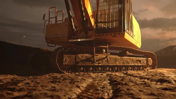 Excavator or digger at muddy construction site during sunset. Demolition, mining