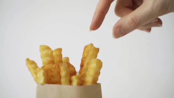 Woman Taking Out French Fry From Box