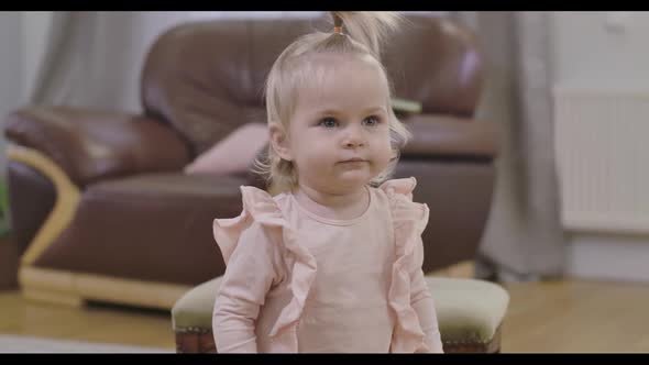 Close-up Face of Extremely Beautiful Caucasian Baby Girl with Blond Hair and Deep Grey Eyes