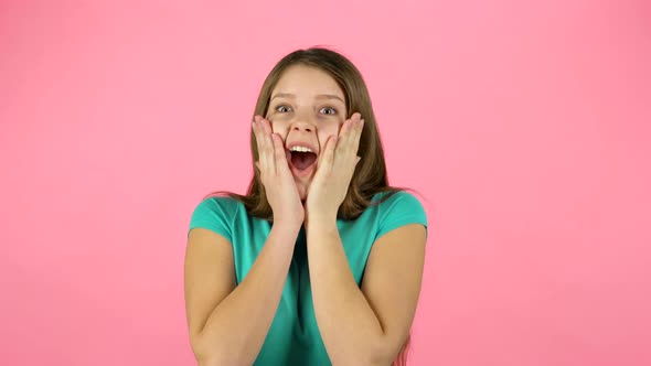 Little Woman Is Surprised and Clapping Her Hands on Pink Background.