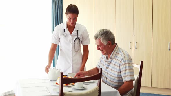 Nurse offering a cake to his patient