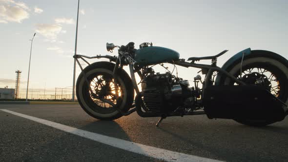 Closeup Dolly Shot of Custom Cafe Racer Motorcycle at Sunset on Street