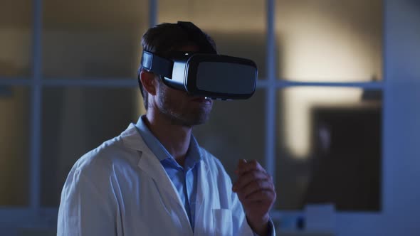 Caucasian male doctor wearing vr headset using virtual interface