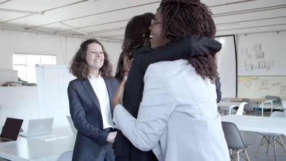 Cheerful Businesswomen Applauding and Hugging