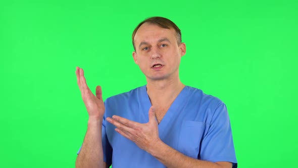 Medical Man Talking and Pointing Side Hand for Something, Copy Space. Green Screen