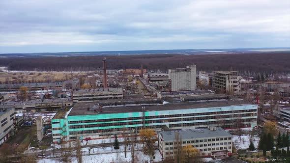 Old ruined industrial plant. Abandoned place with ruined buildings on nature background.