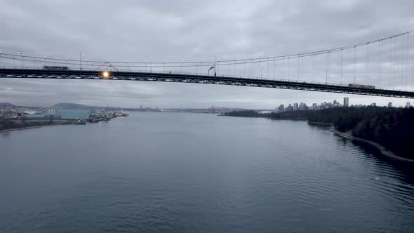 Drone flying under Lions Gate Bridge, Vancouver in Canada. Aerial forward