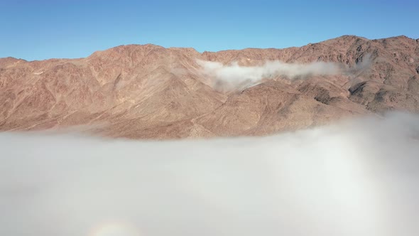 Aerial View From Drone Flying Over Mountains and White Fog Clouds at Sunrise