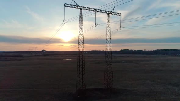 Aerial Video of the Electric Pole with Wires Against Sky at Sunset