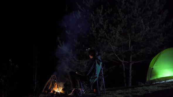 Camping tent and camper at night.