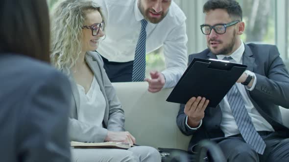 Laughing Boss Wagging Finger at Businesswoman