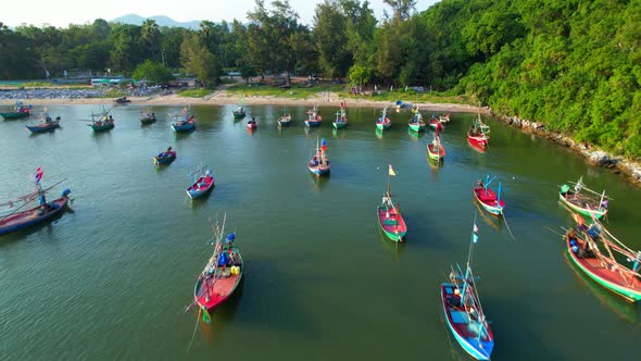 Many fishing boats on the coast beside the mountains, beautiful sea area in Thailand.