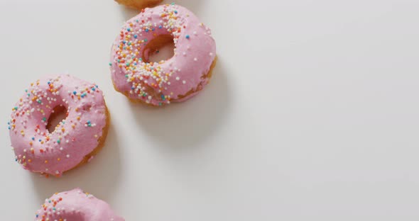 Video of donuts with icing on white background