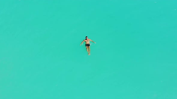 A Young Male Model Swimming Alone In the Turquoise Caribbean Sea