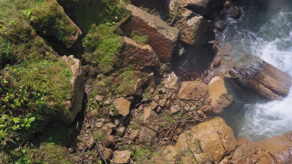 Waterfall crashes next to big rocks