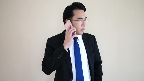 Asian young businessman talking at phone.