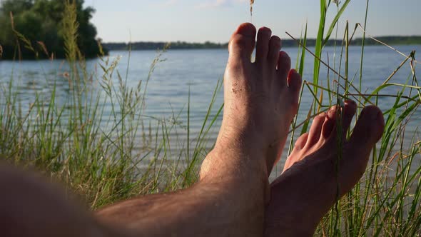 Bare Feet of a Man in Nature Near the River