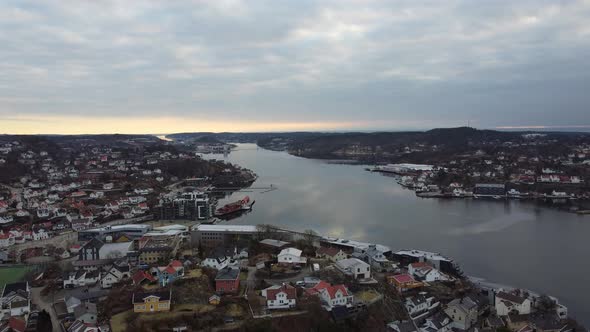 Arendal evening aerial with sunset reflections in sea surface - View above city center and northeast