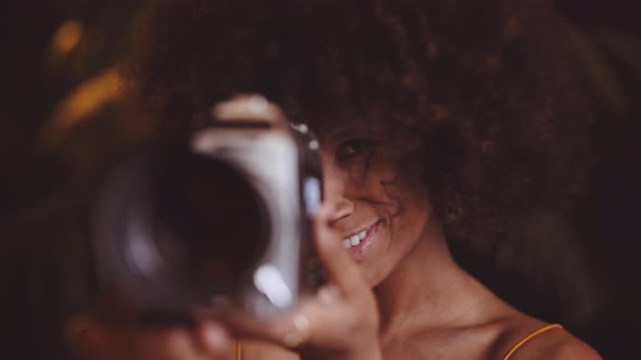 Woman With Afro Hair Using Vintage 8Mm Camera