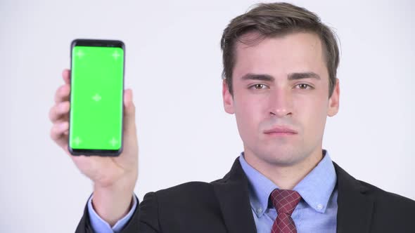 Young Happy Handsome Businessman Showing Phone