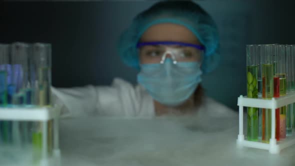 Biologist Opening Fridge and Dripping Liquid in Tube With Green Plant, Biofuel