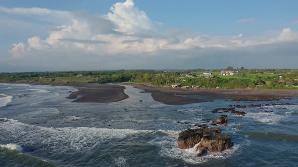 Aerial Footage of Black Volcanic Beach, Green Rice Terraces. Bali, Indonesia