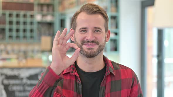 Portrait of Ok Sign By Approving Young Man 