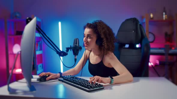 Young Woman Wearing Headphones Playing Computer Game Neon Fashion Room Winner