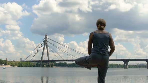 Slim Woman Doing Asana, Yoga Pose, Enjoying Solitude and Freedom in Big City