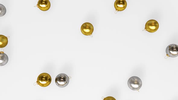 Several Silver And Gold Christmas Balls Falling To The Floor alt