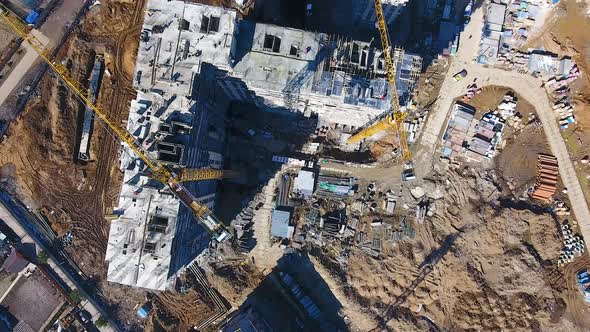 Drone flies Over a Construction Site near Moscow Construction Cranes in the Industrial Zone