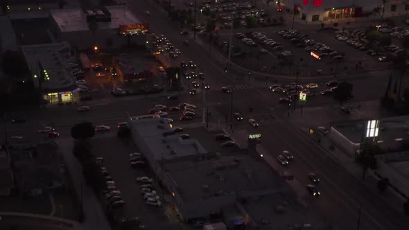 AERIAL: View of Culver City, Los Angeles, California Traffic, Intersection at Dusk with Car Traffic