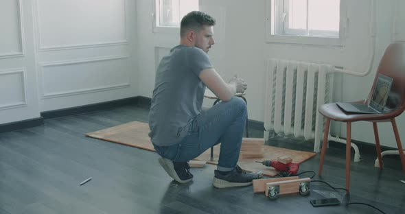 Man is Building Furniture Himself Making Renovation at Home