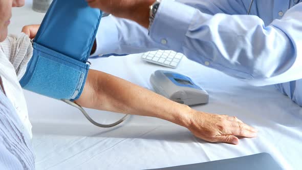 Doctor checking blood pressure of a patient