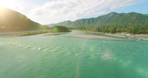 Low Altitude Flight Over Fresh Fast Mountain River with Rocks at Sunny Summer Morning.