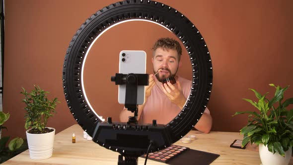 Young Man Filming His Video Blog Episode About New Cosmetic Products While